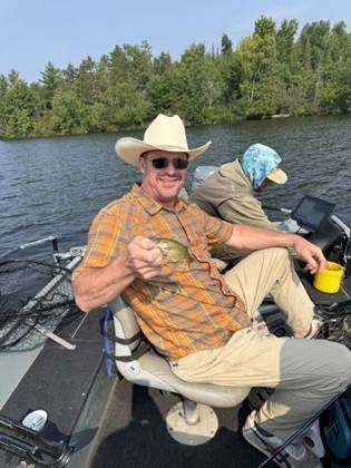 Ed proudly holding a very small fish